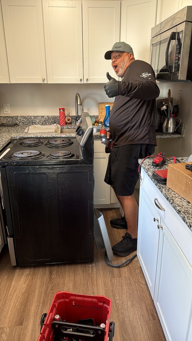 Al repairing a kitchen range in an Orlando home