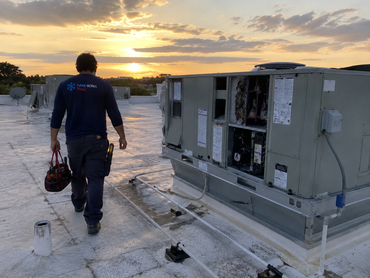 HVAC technician from Arctic Air HVAC servicing an air conditioning system in Orlando, Florida