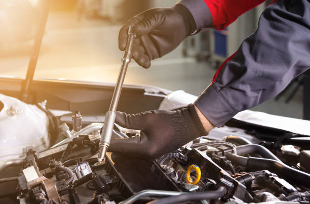 A mechanic repairing a vehicle in an Orlando driveway