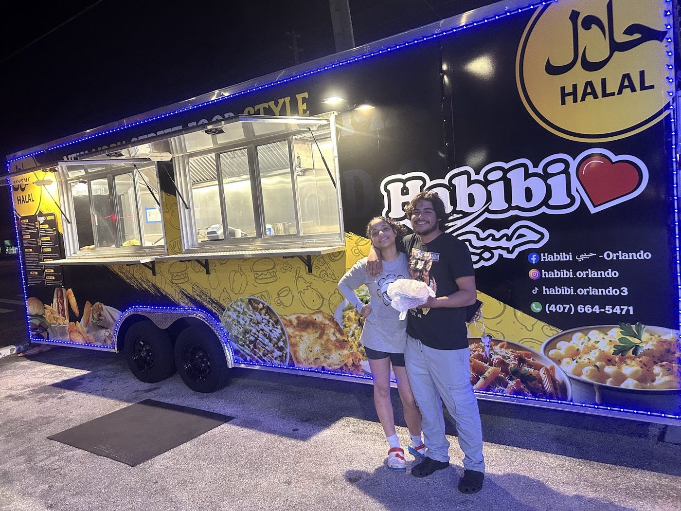 The Habibi food truck glowing at night on Colonial Drive