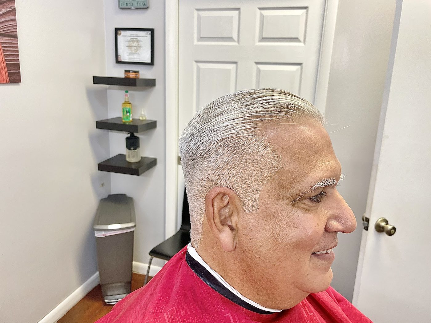 Clean senior haircut and slick-back finish