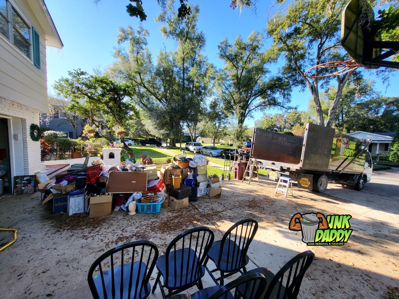 A Junk Daddy Junk Removal crew hauling junk in Orlando, Florida