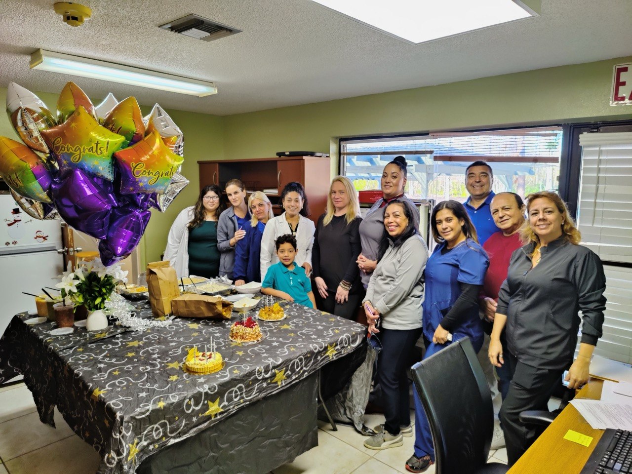 The Nona Medical Services team celebrating together in the office