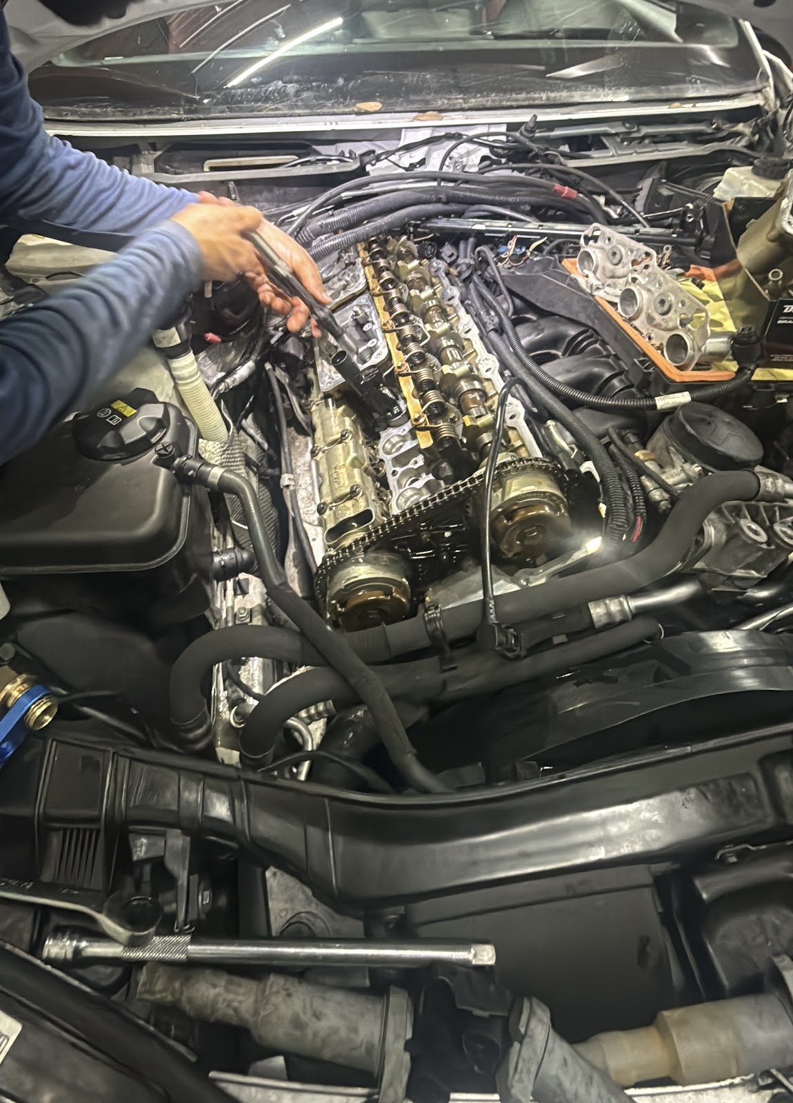 A mechanic repairing a vehicle in an Orlando driveway