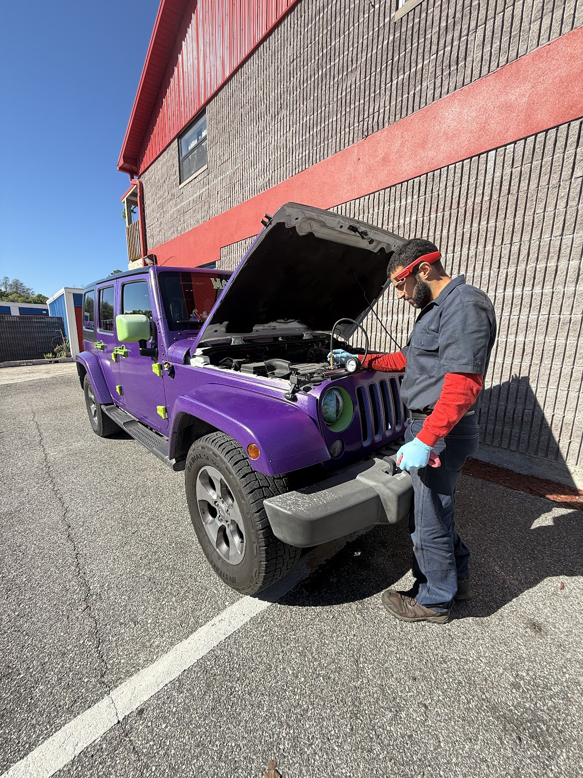 our mechanic working under the hood at a customer's home