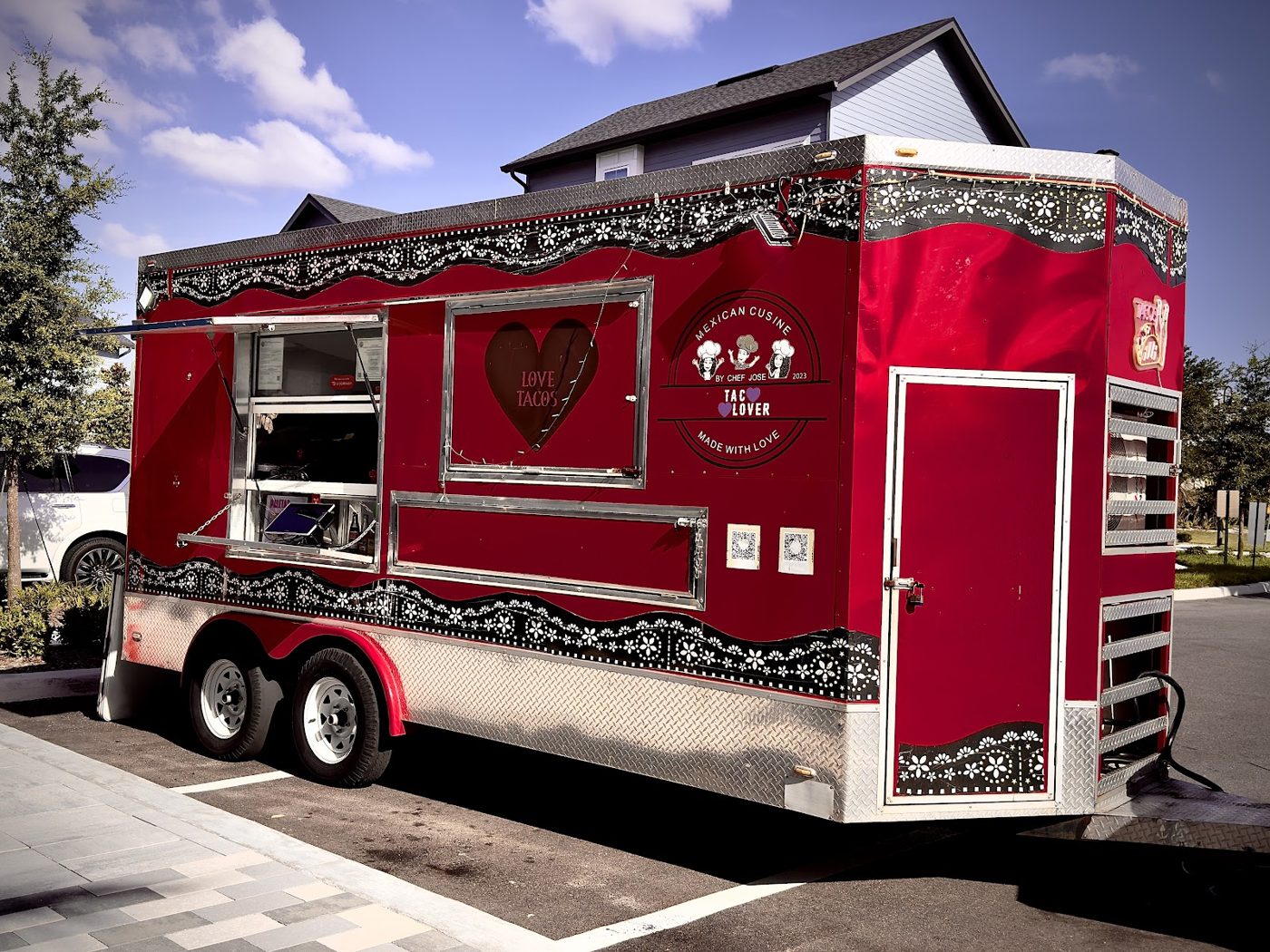 The red Tacolover food truck parked in Moss Park, Orlando