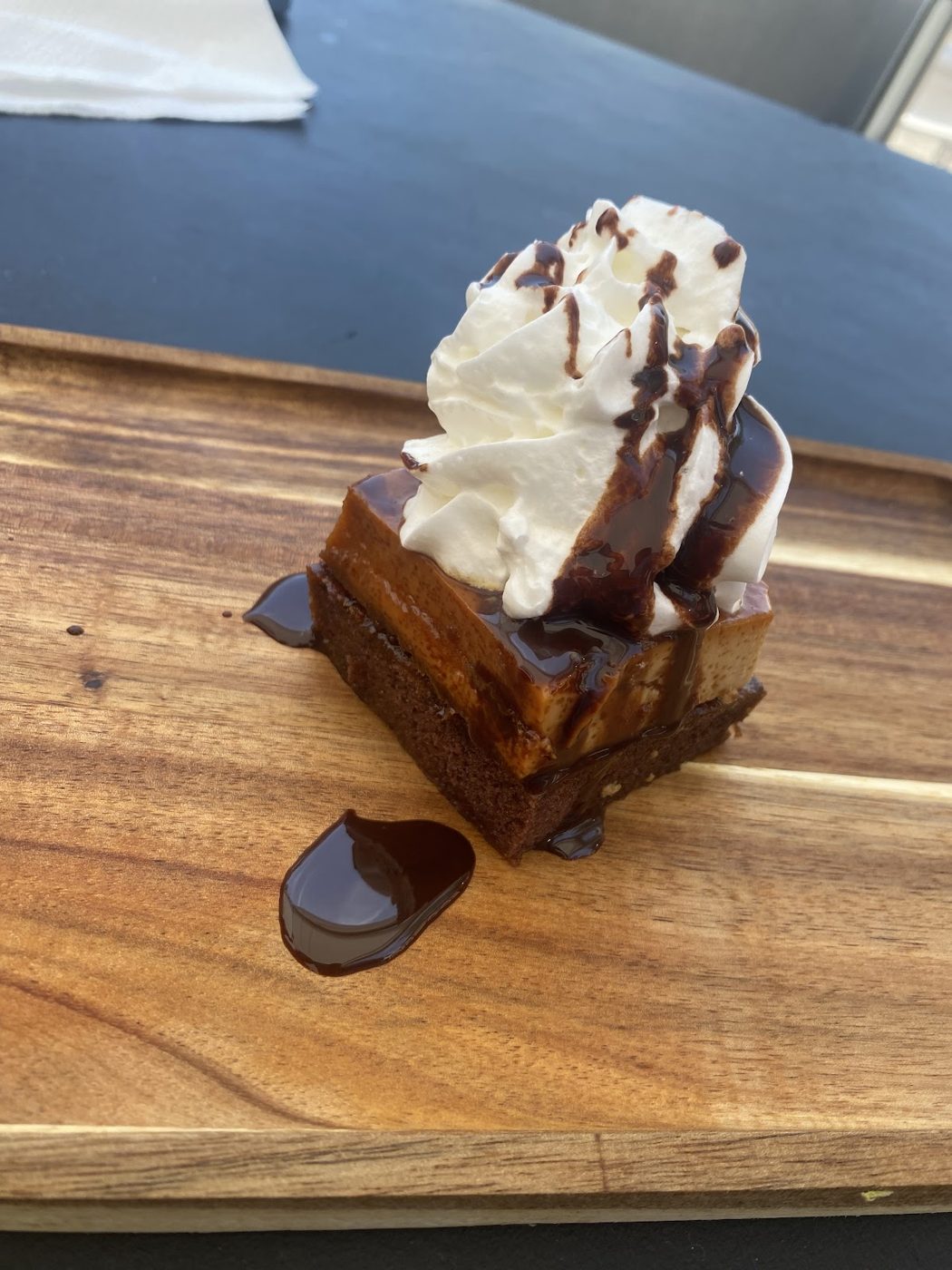 Tacolover chocoflan dessert with whipped cream and chocolate drizzle